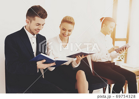 Man with woman reads books and smile. Man with woman reads books and smile. 69754328