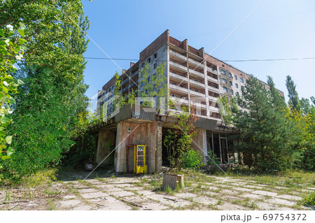 Phone box near abandoned building in centre of ghost town Pripyat Chornobyl Zone Phone box near abandoned building in centre of ghost town Pripyat Chornobyl Zone 69754372
