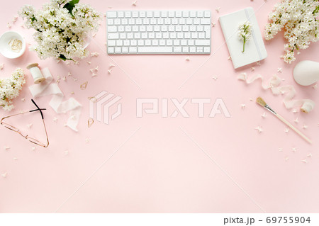Office table desk with computer, lilac, clipboard. magazines. Top view Flat lay. Home office workspace. Women's fashion accessories on pink background Office table desk with computer, lilac, clipboard. magazines. Top view Flat lay. Home office workspace. Women's fashion accessories on pink background 69755904