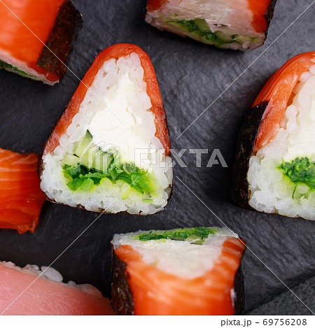 Seafood delicatessen salmon sushi rolls on plate 69756208