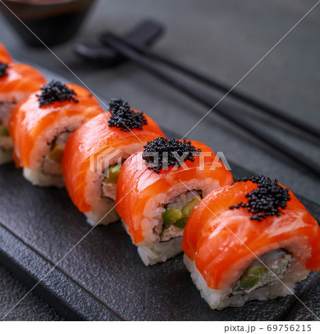 Seafood delicatessen salmon sushi rolls on plate Seafood delicatessen salmon sushi rolls on plate 69756215