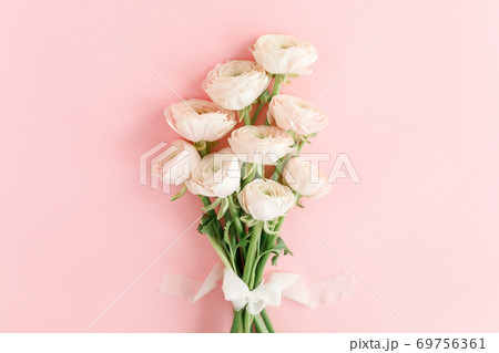 Pastel pink ranunculus flowers bouquet on pink background. Minimal floral concept. Flat lay, top view. 69756361