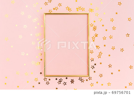 Photo frame mock up with space for text, golden confetti on a pink background. Colorful celebration. Christmas or New Year pattern. Flat lay, top view 69756701