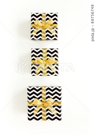 Gift or present boxes and stars confetti on a white background. Colorful celebration, birthday. Christmas or New Year pattern. Flat lay, top view Gift or present boxes and stars confetti on a white background. Colorful celebration, birthday. Christmas or New Year pattern. Flat lay, top view 69756749