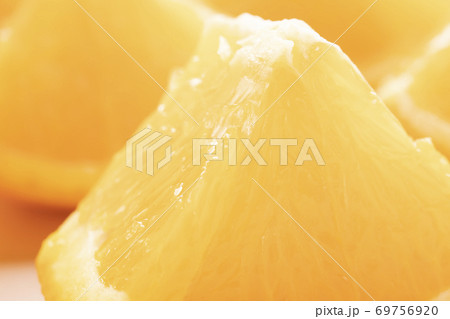 Freshly sliced oranges on a dotted brown plate. Macro with selective focus. Energy nutrition concept 69756920