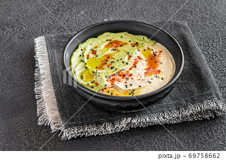 Bowl of guacamole and hummus Bowl of guacamole and hummus 69758662