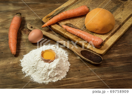 Orange dough bun for noodles with ingredients on the table. Orange dough bun for noodles with ingredients on the table. 69758909