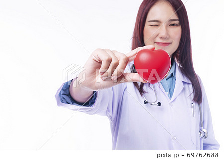 Selective focus hand of friendly doctor woman wear uniform with stethoscope hold red heart, 69762688