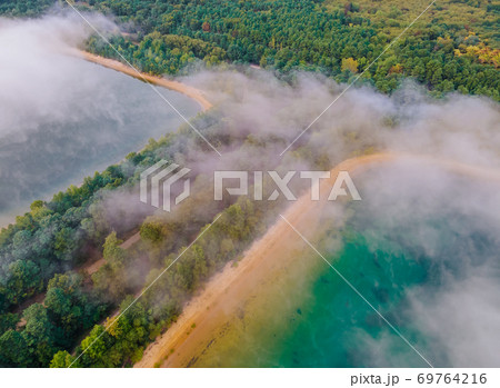 Morning fog over the lake aerial view of mist fog landscape in the forest 69764216