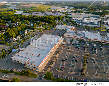 Aerial view shopping mall of goods with a lot of parking space Aerial view shopping mall of goods with a lot of parking space 69764479
