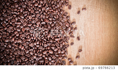Roasted coffee beans on wooden background with copy space. Natural texture background. 69766213