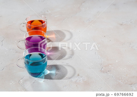 Glasses with colored liquid on a light marble background 69766692