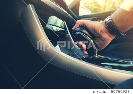 The driver's hand holds the gear lever 69766928