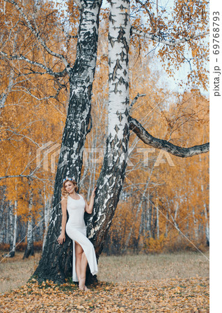 beautiful girl in a white dress in the autumn forest. nature walk. 69768793