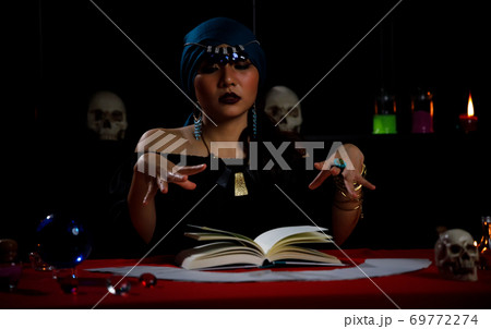 Fortune teller use horoscope book to forecast fate or destiny of people. Fortune teller use horoscope book to forecast fate or destiny of people. 69772274