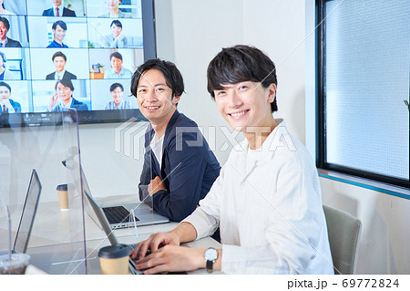 アクリルパーテーションのある会議室でオンライン会議　ビデオ会議　リモートワーク　テレワーク 69772824