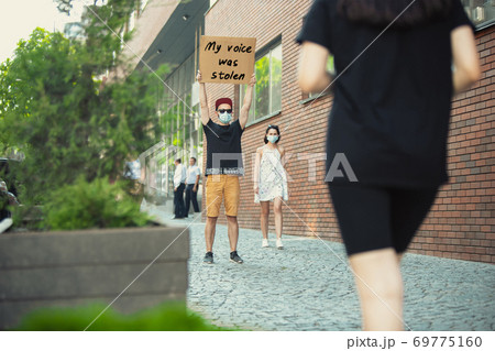 Dude with sign - man stands protesting things that annoy him 69775160