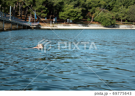 Man woman nudist Nude man carrying nude woman into water - SuperStock