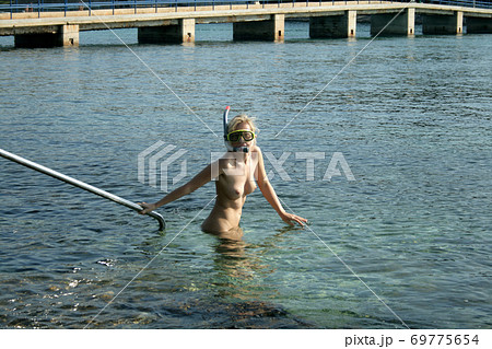 Naked woman on the nudist beach 69775654
