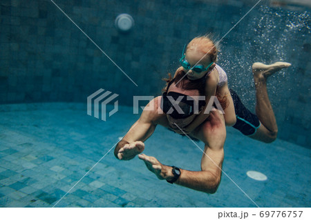 father and daughter swimming father and daughter swimming 69776757