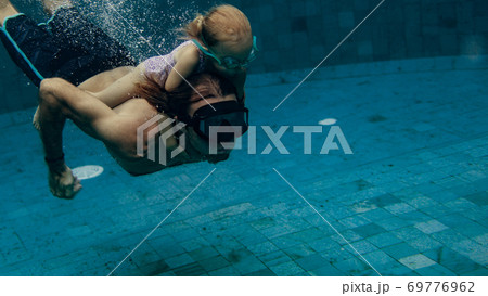father and daughter swimming father and daughter swimming 69776962