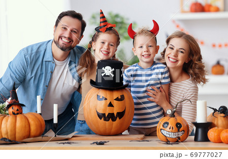 Delighted family during Halloween celebration. 69777027