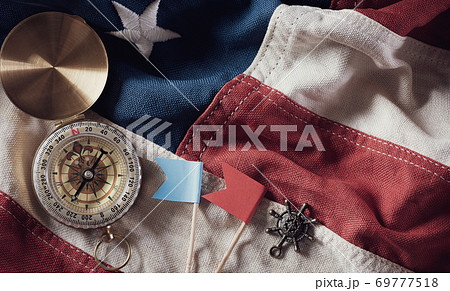 Happy Columbus Day concept. Vintage American flag with compass and retro treasure manuscript.  Flat lay, top view with copy space. 69777518