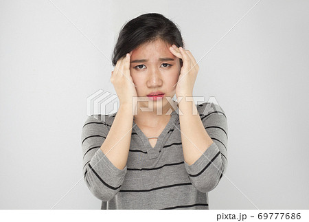 young asian woman arms raised touch her head feel headache young asian woman arms raised touch her head feel headache 69777686