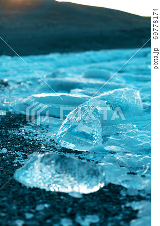 Clear transparent ice on a black beach in Iceland in winter Clear transparent ice on a black beach in Iceland in winter 69778174