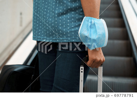 passenger man wearing a face mask in his arm 69778791