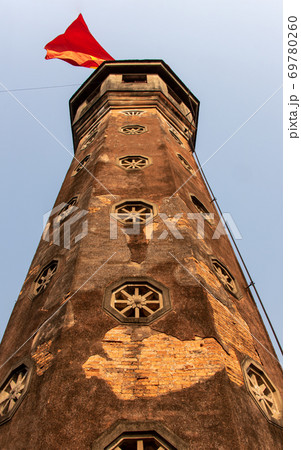 Tower with fluttering national flag at Hanoi know as The Flag Tower of Hanoi, Vietnam. Tower with fluttering national flag at Hanoi know as The Flag Tower of Hanoi, Vietnam. 69780260