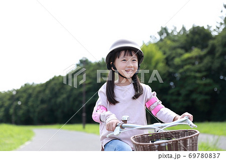 自転車の補助輪を取って練習をする女の子 69780837
