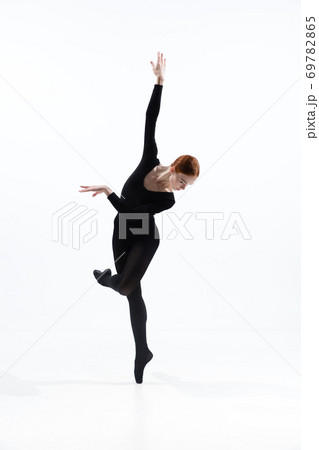 Young and graceful ballet dancer in minimal black style isolated on white studio background 69782865