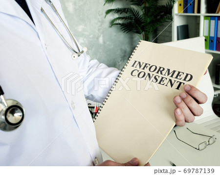 Doctor shows documents and informed consent form. 69787139