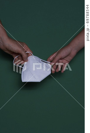Child and woman's hand with protective mask 69788544