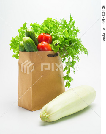Healthy food. Fresh herbs and vegetables in kraft paper bag on white background 69788606
