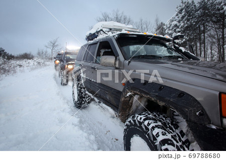 One SUV 4x4 cars go on snowy road, winter season One SUV 4x4 cars go on snowy road, winter season 69788680