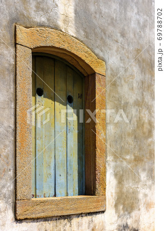 Historic church window in colonial style with stone frame Historic church window in colonial style with stone frame 69788702