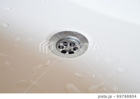 Drain in a white clean sink grate close-up 69788804