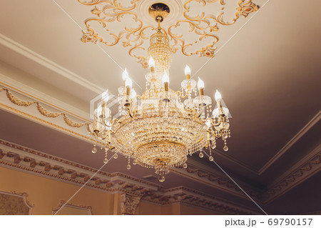 Chrystal chandelier lamp on the ceiling in Dining room Adjusting the image in a Luxury tone .Decorative elegant vintage and Contemporary interior Concept. Chrystal chandelier lamp on the ceiling in Dining room Adjusting the image in a Luxury tone .Decorative elegant vintage and Contemporary interior Concept. 69790157