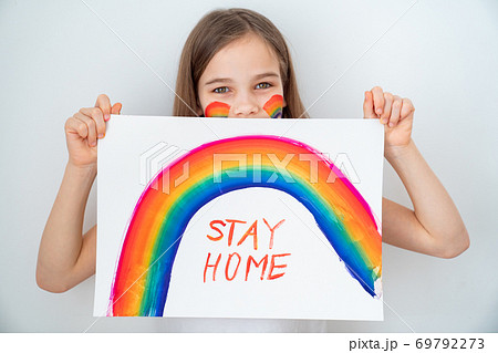 blond teen girl drew rainbow and poster stay home. blond teen girl drew rainbow and poster stay home. 69792273