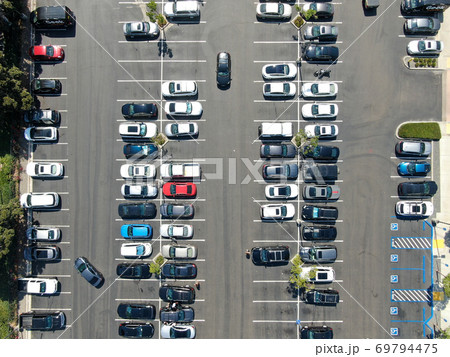 Aerial top view of parking lot at shopping mall with varieties of colored vehicles. Aerial top view of parking lot at shopping mall with varieties of colored vehicles. 69794475