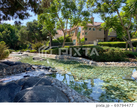 Public Park with green garden and landscape design with water pond and water stream 69794477