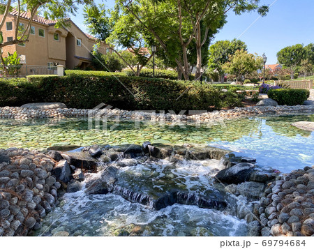 Public Park with green garden and landscape design with water pond and water stream Public Park with green garden and landscape design with water pond and water stream 69794684