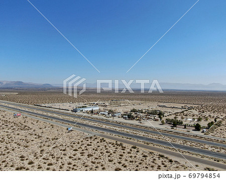 Aerial view of road in the middle of the desertの写真素材