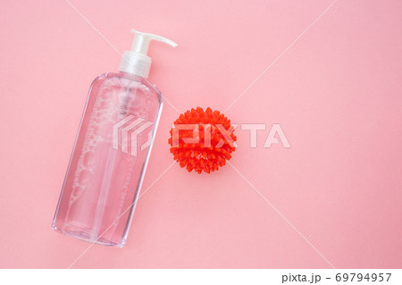 bottle of antiseptic and model COVID-19 on pink. bottle of antiseptic and model COVID-19 on pink. 69794957