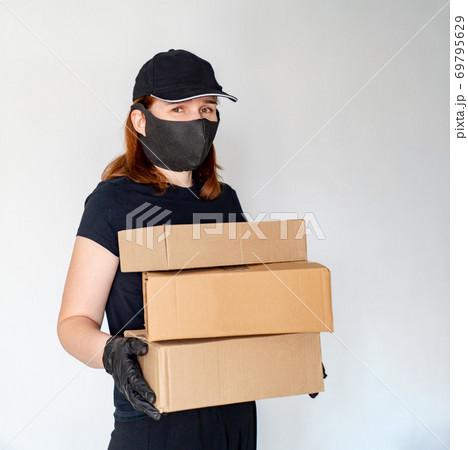 woman Delivery person holding boxes woman Delivery person holding boxes 69795629