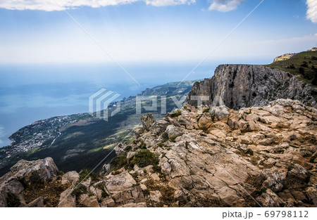 Stones on top of the Crimean mountains on the background of the valley on the Black sea in the fog 69798112
