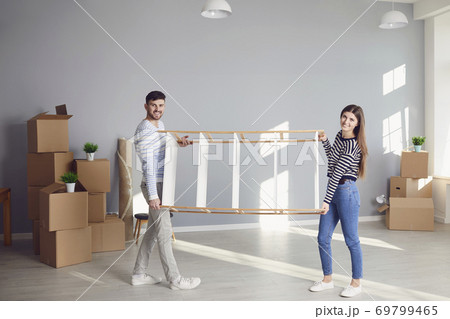 Young couple family with boxes to move in a new house room. 69799465