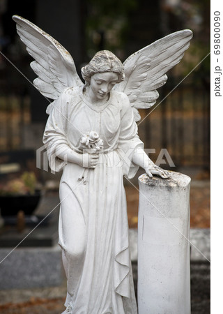 Closeup of stoned angel on tomb in a cemetery 69800090